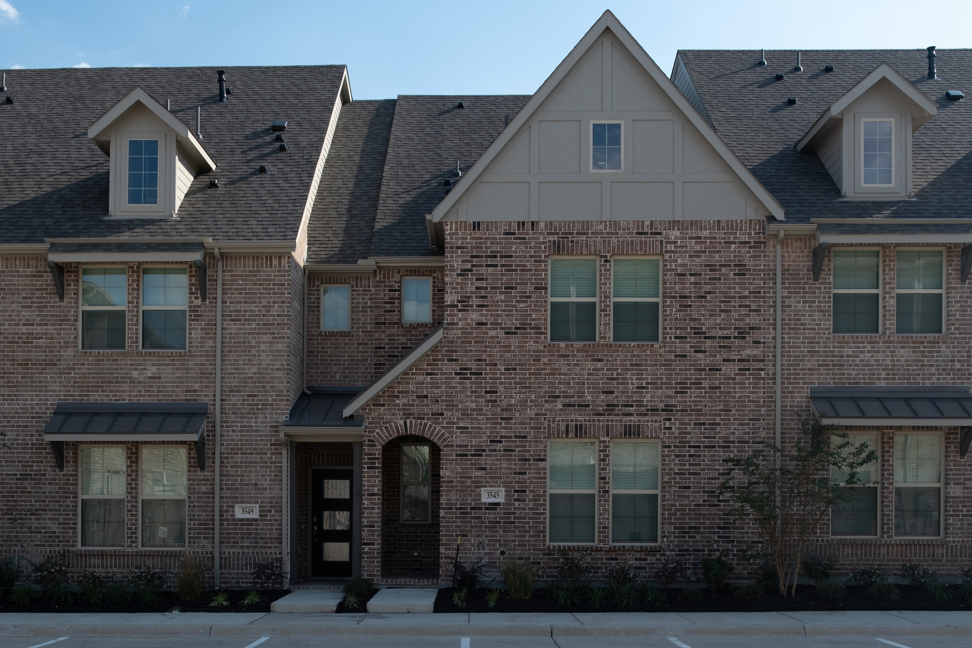 exterior of home with brown brick and covered front porch