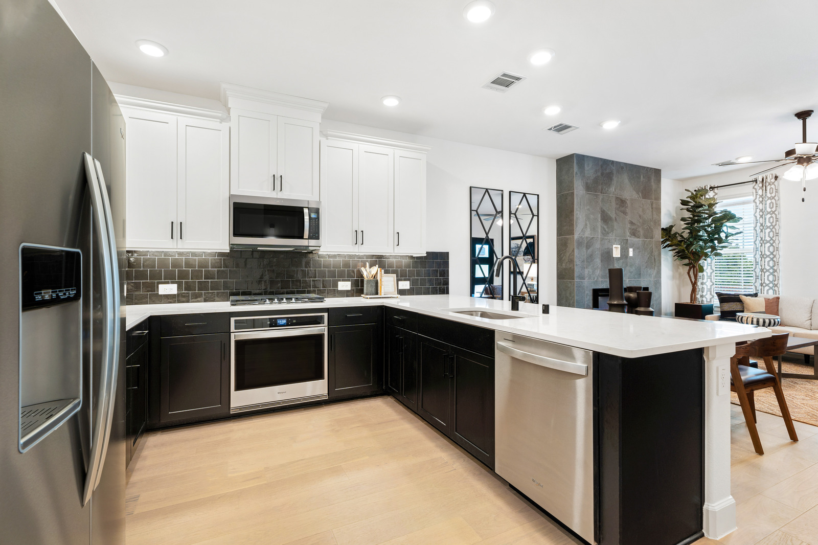 kitchen with black cabinets and hardwood floors