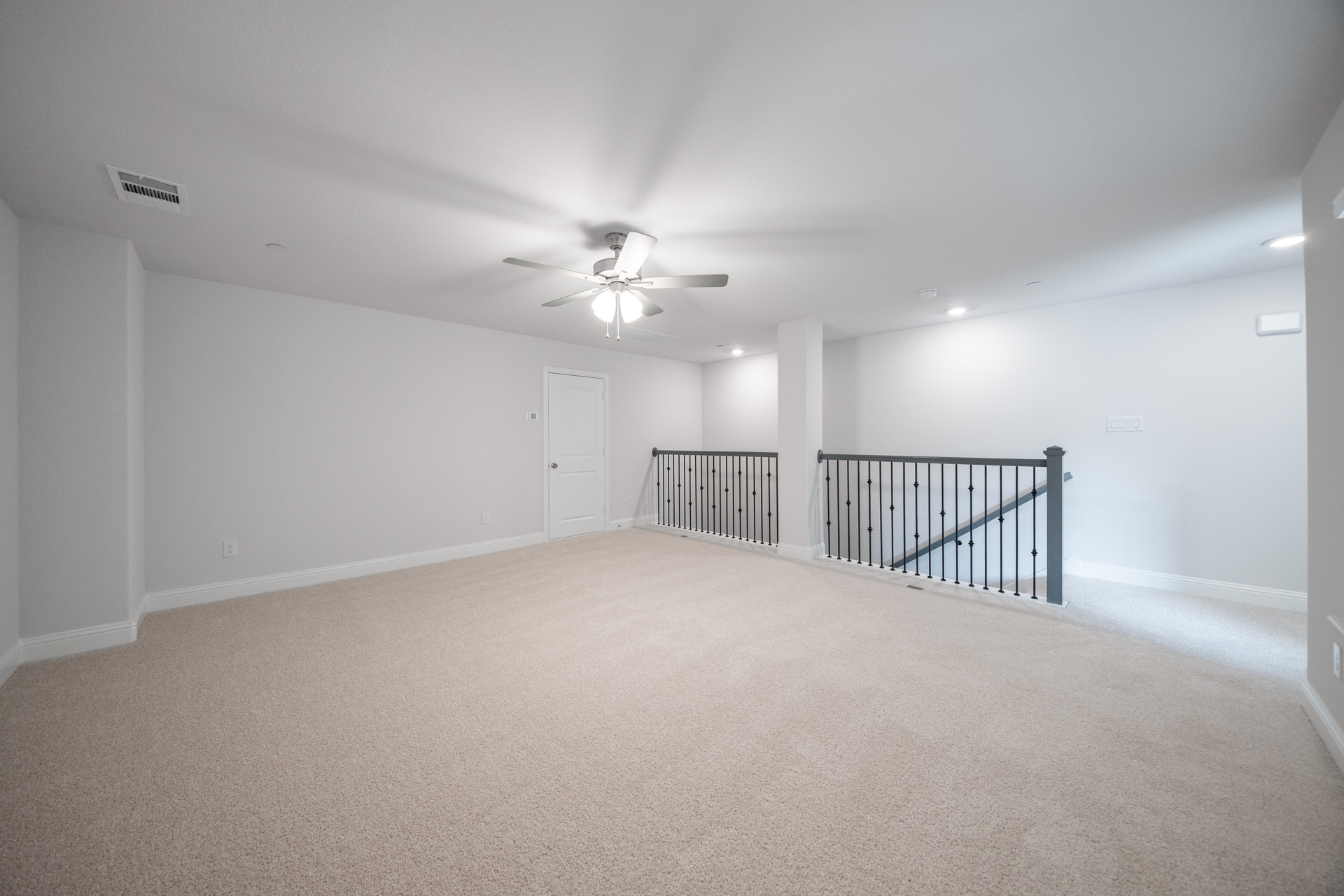 spacious loft with carpet and windows