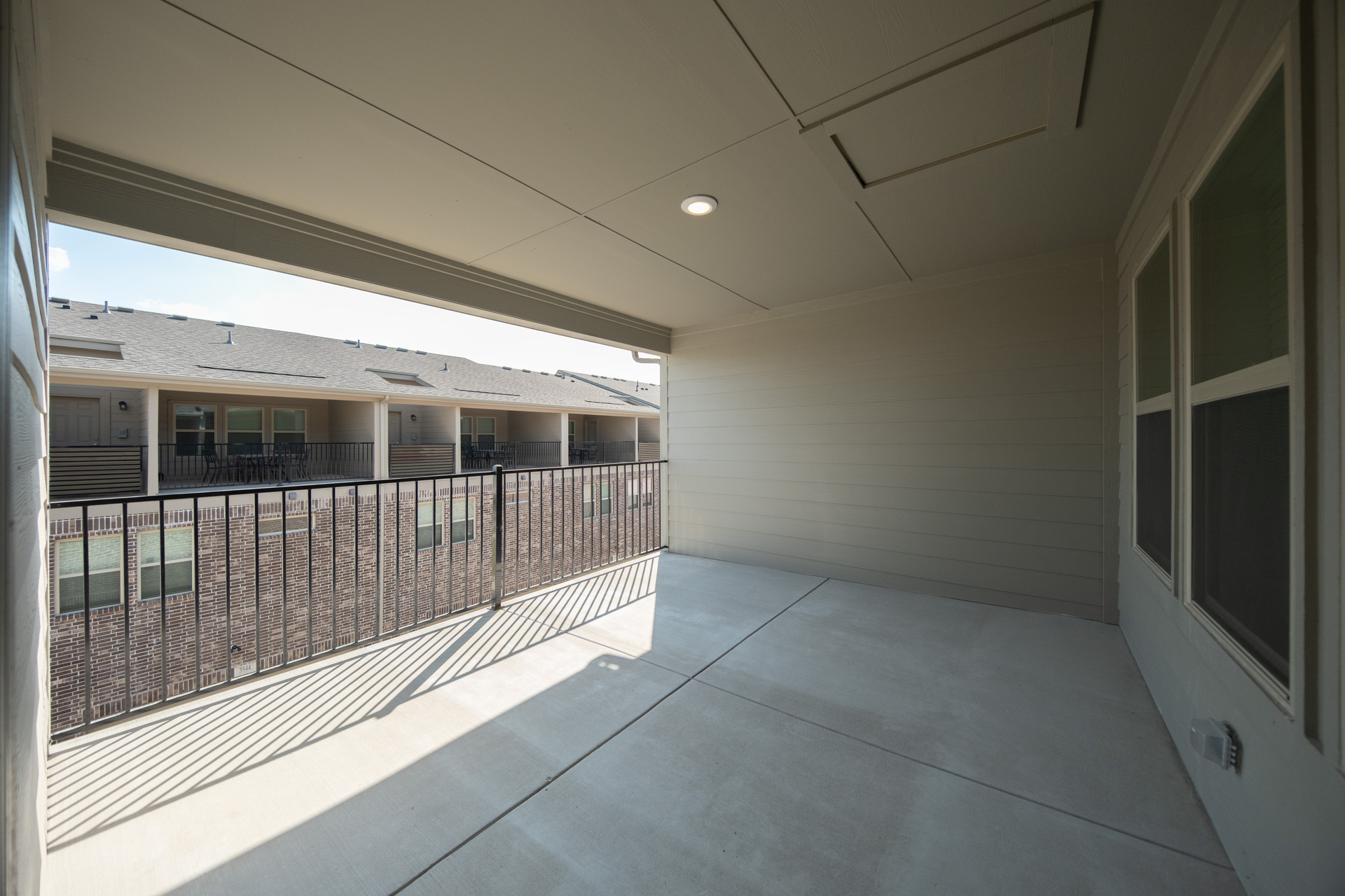 spacious third-floor covered terrace with iron railing