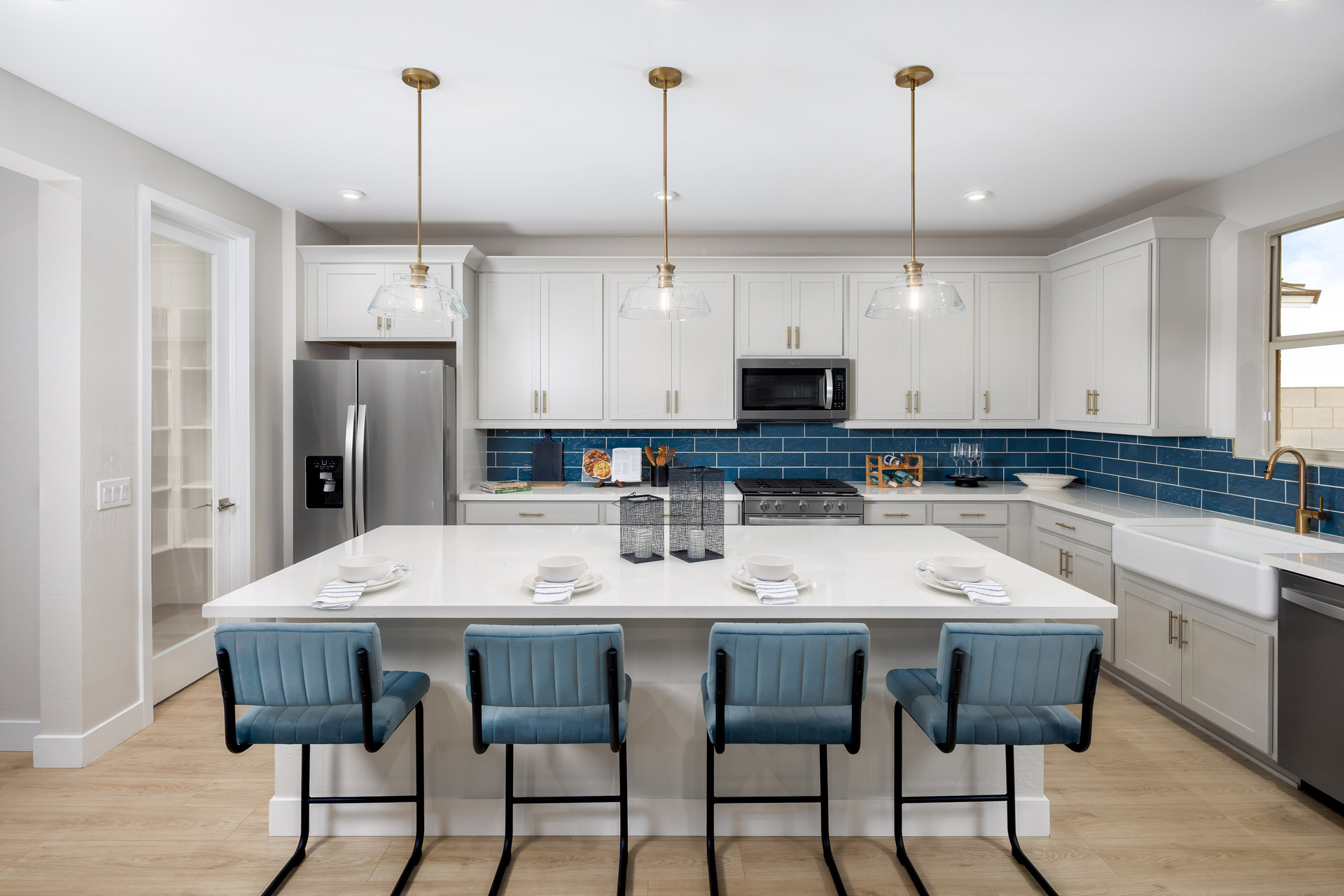 kitchen with white cabinets, quartz countertops, and teal barstools