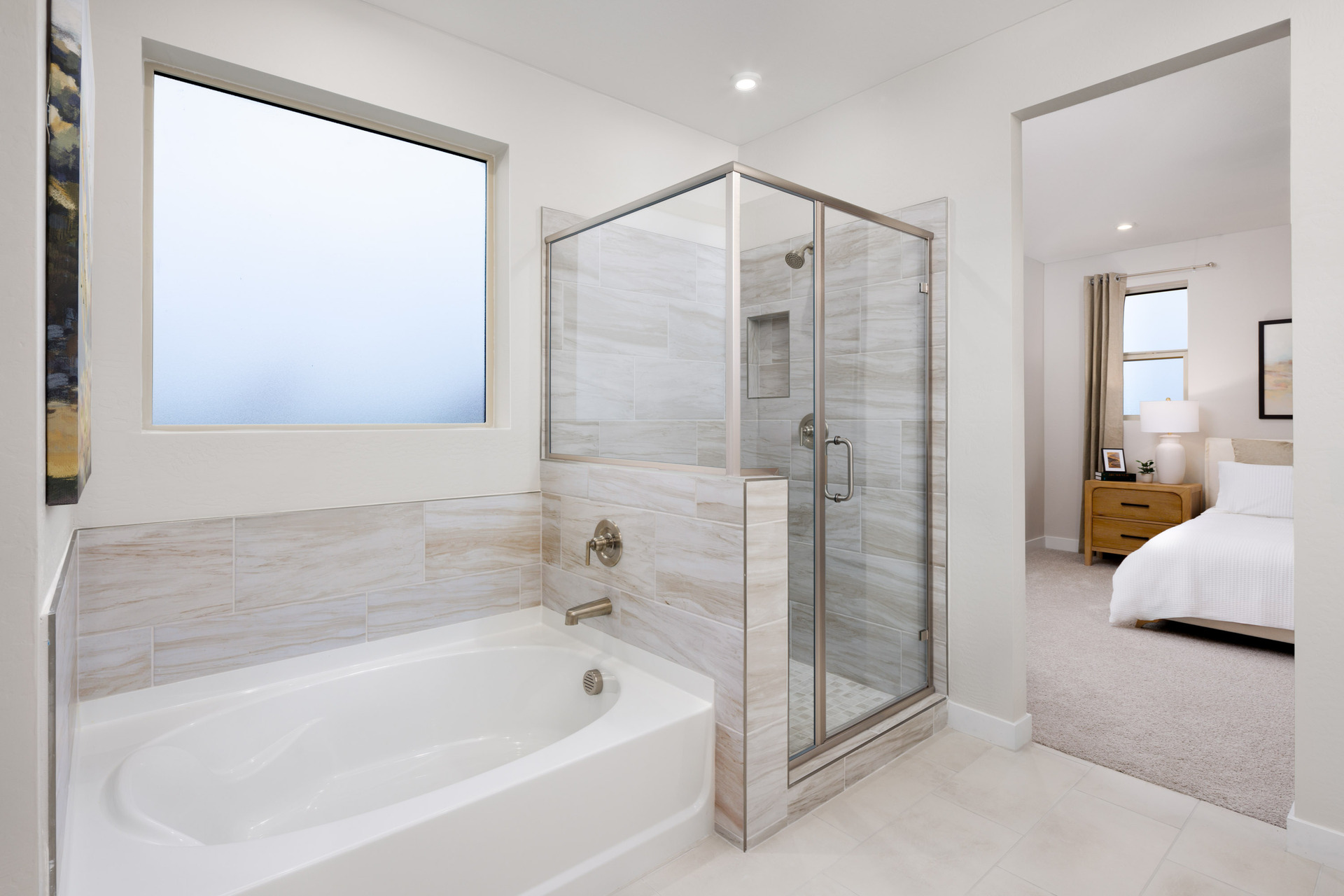 bathroom with a walk-in shower and soaking tub