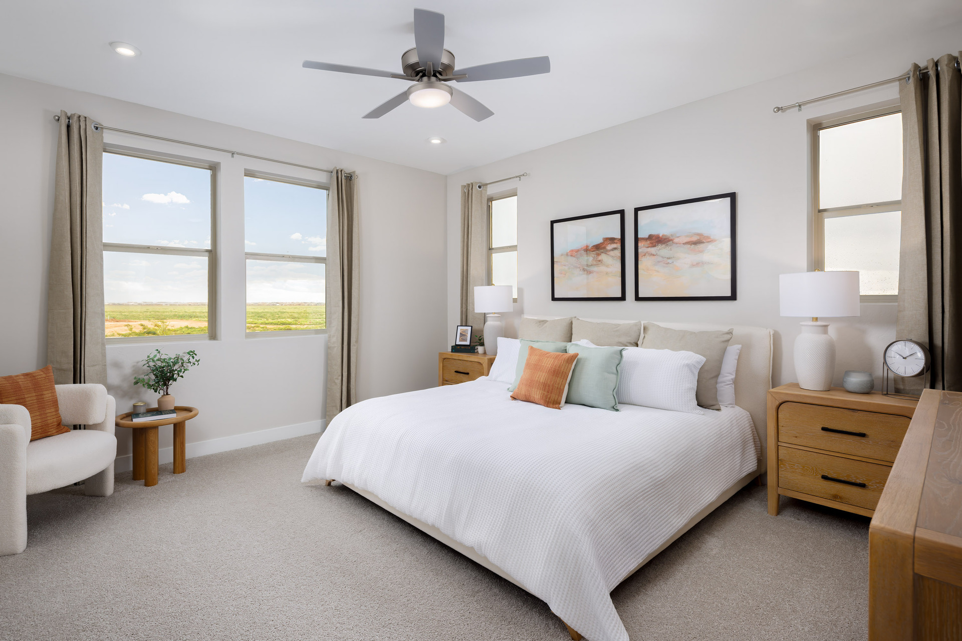 spacious bedroom with a large white bed and wooden nightstands