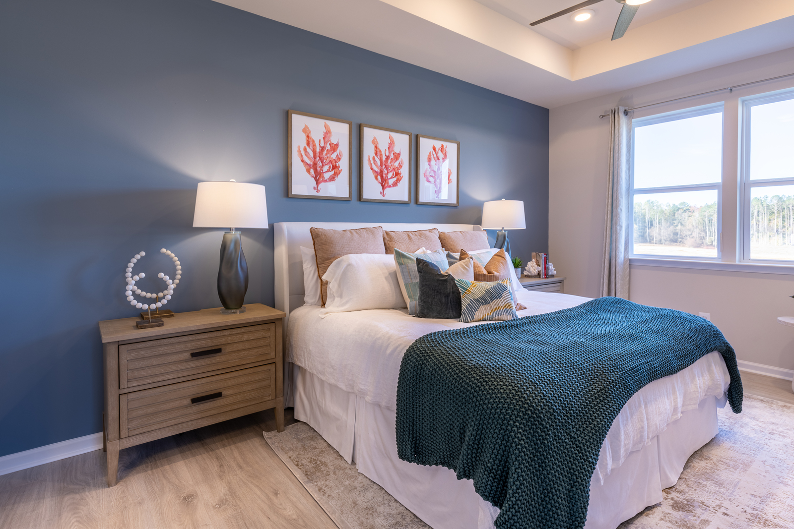 primary suite with a box ceiling fan