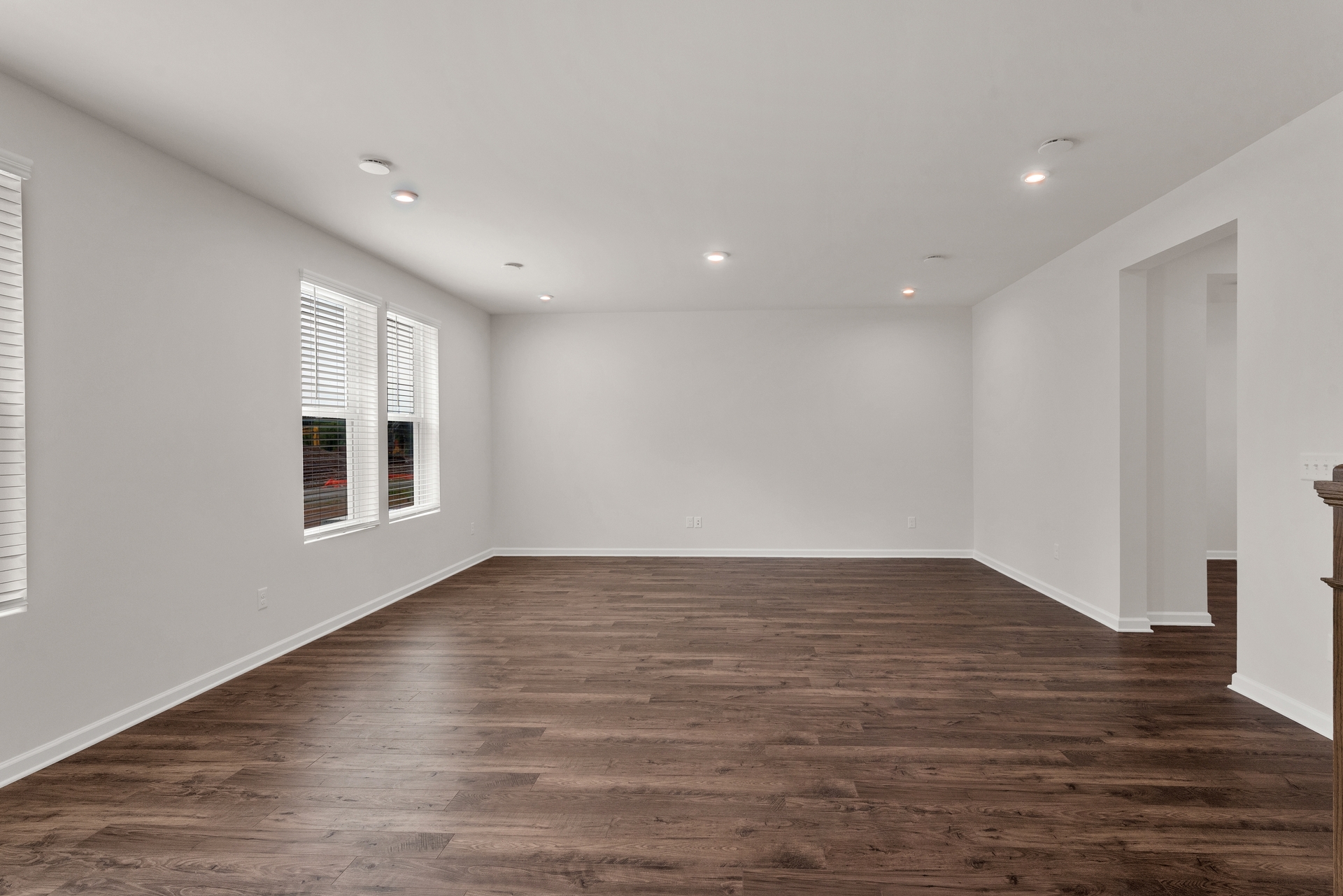 great room with wood plank flooring and windows letting in natural light