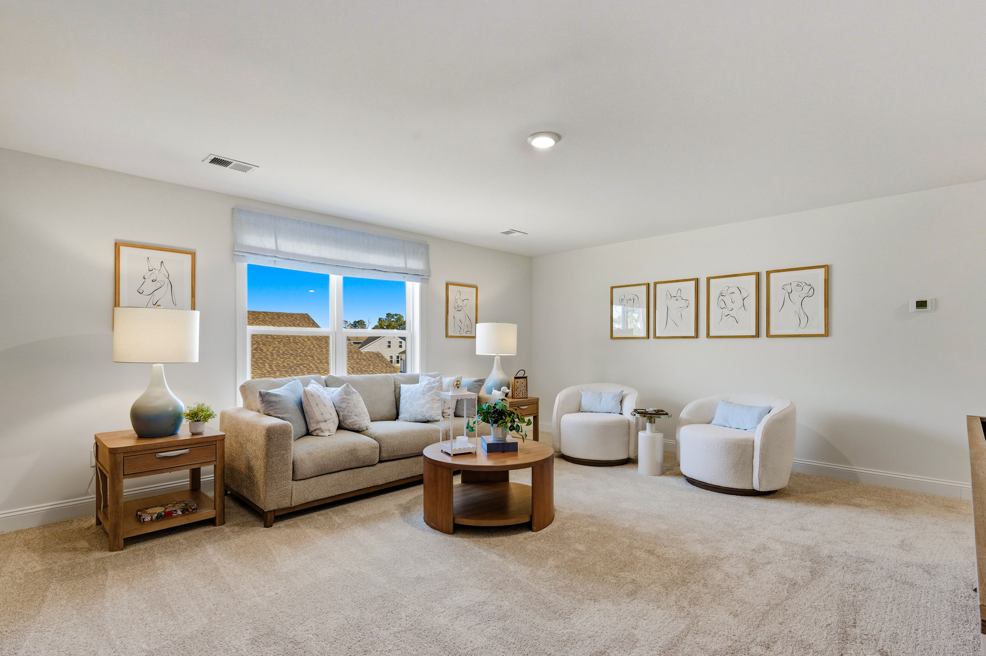 four photos on the wall with a couch