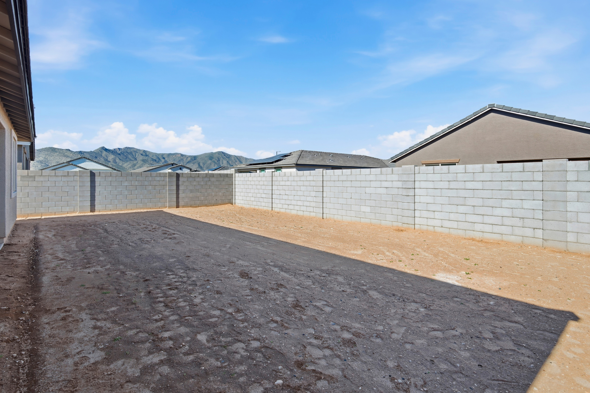 spacious backyard with concrete block wall