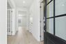 foyer with black entry door, white walls, light wood floor and a study with french doors