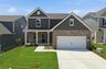 home exterior with brick, covered patio, and two car garage