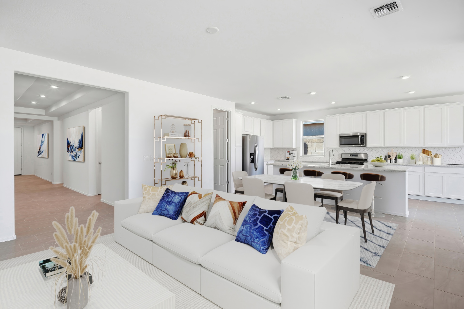spacious great room large white couch, and dining table 