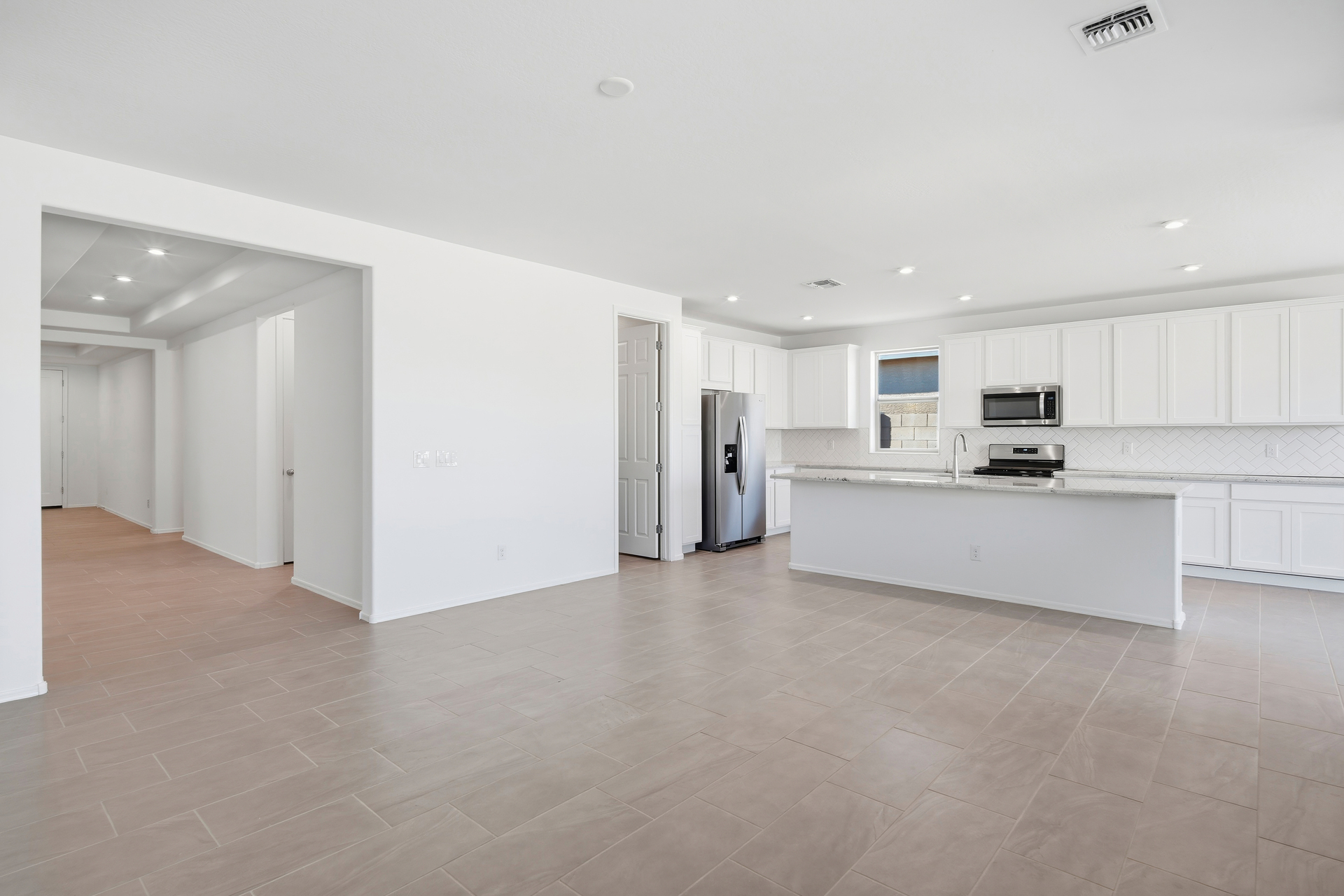 open-concept space with tile flooring and recessed lights