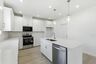 kitchen with white walls, white cabinets, and stainless steel appliances