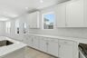 kitchen with white walls, white cabinets, and stainless steel appliances