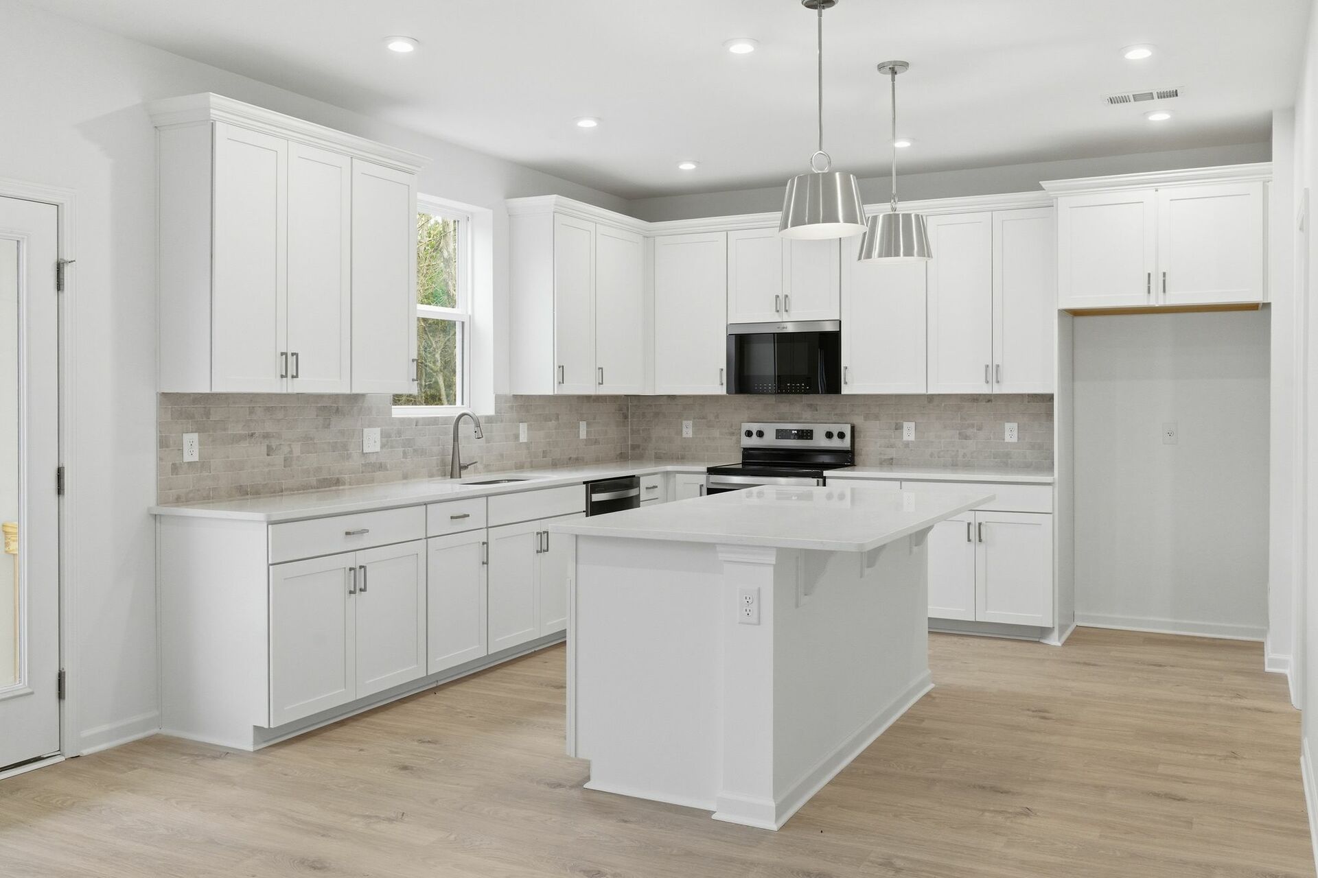 kitchen with wood flooring, white cabinets, and white countertops