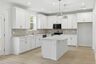 kitchen with wood flooring, white cabinets, and white countertops