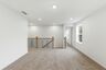 loft space with carpet flooring, white trim, and a window