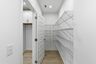 pantry with wood flooring and white wire shelving