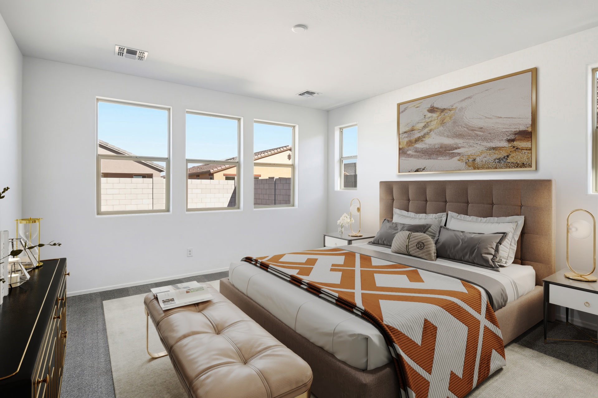 spacious bedroom with large bed with gold/orange accents colors