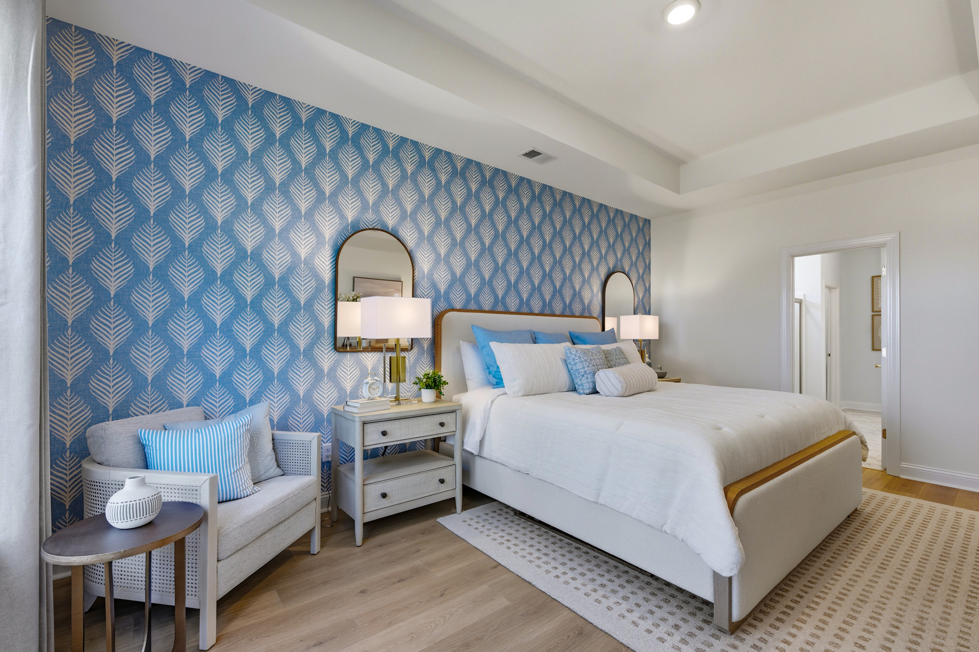 king bed with a blue wallpaper wall