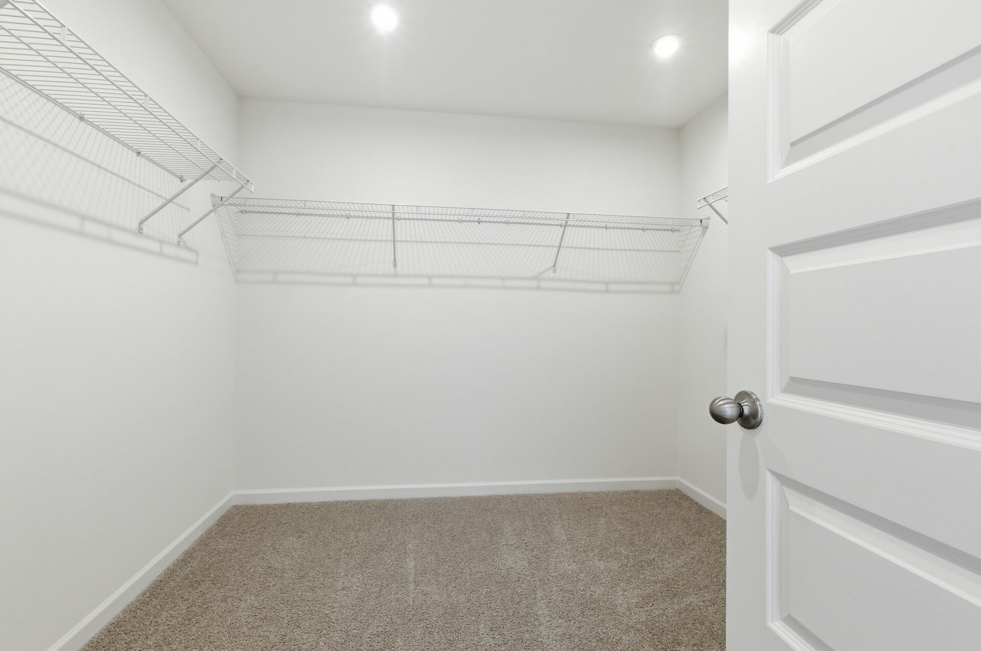 primary walk in closet with built in shelves