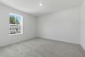 secondary bedroom with carpet, large windows, and walk-in closet