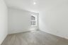 secondary bedroom with carpet, large windows, and walk-in closet