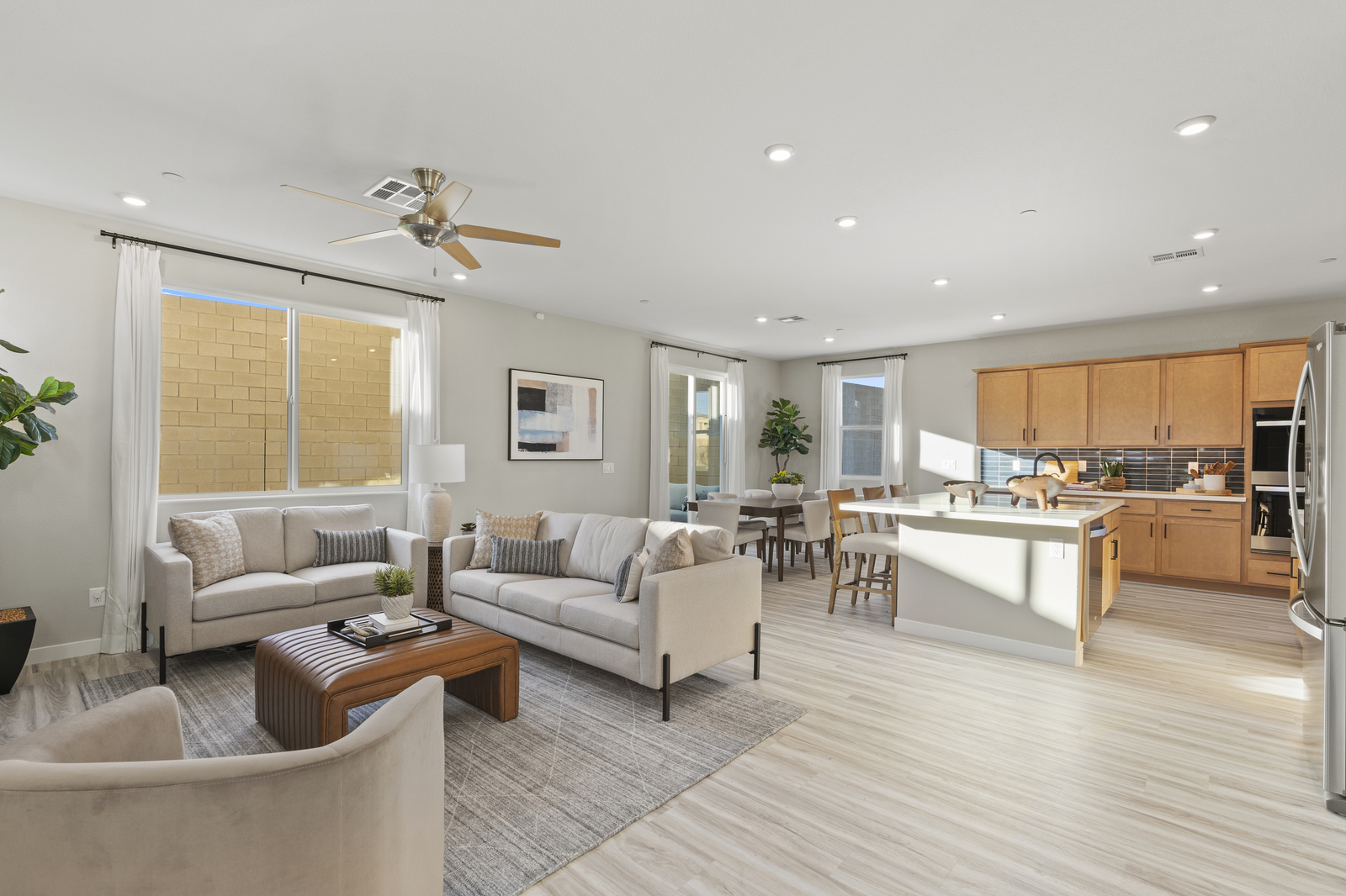 great room with natural lighting and couches