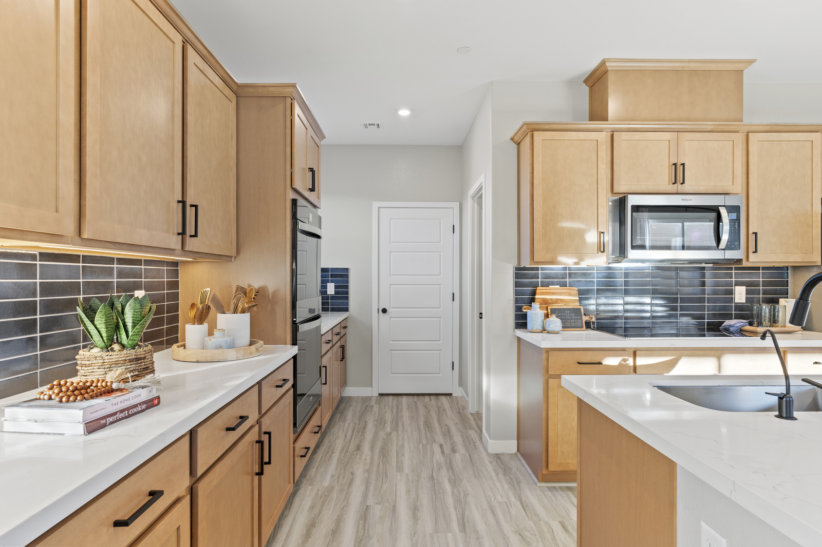 kitchen with tan cabinets and black hardware