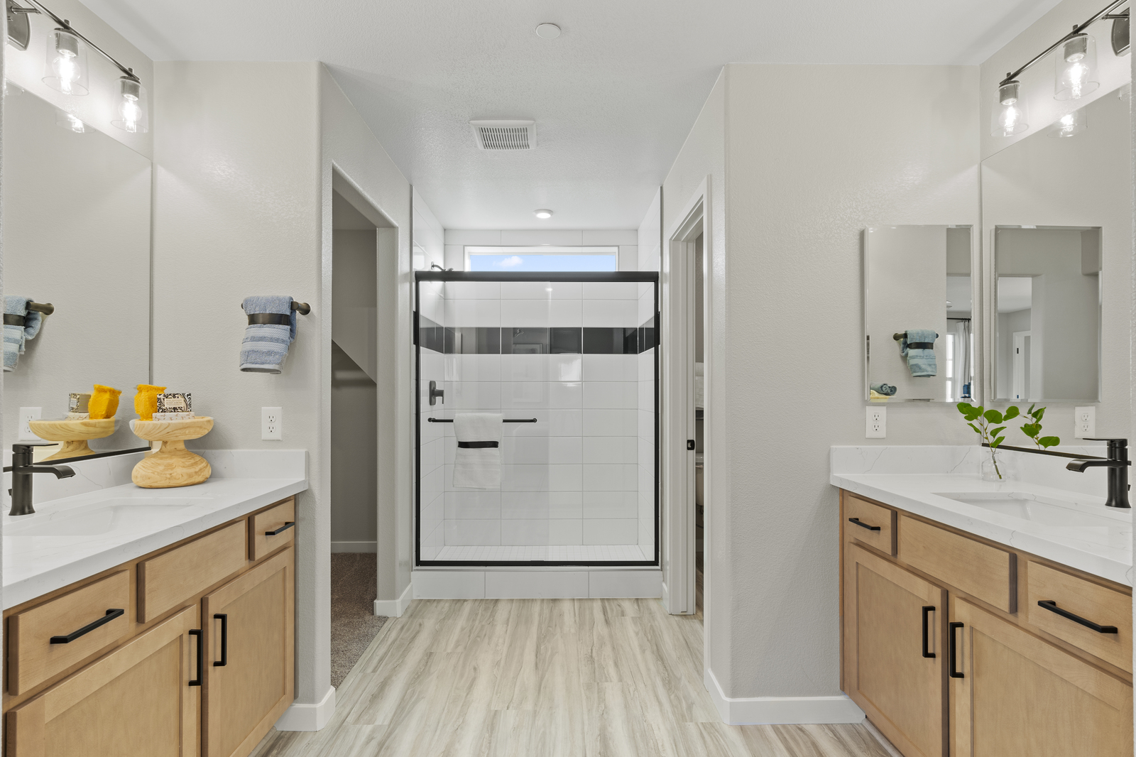 bathroom with tan cabinets and walk-in shower
