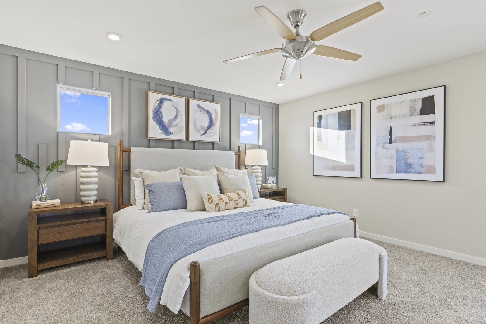 primary bedroom with large bed and accent wall