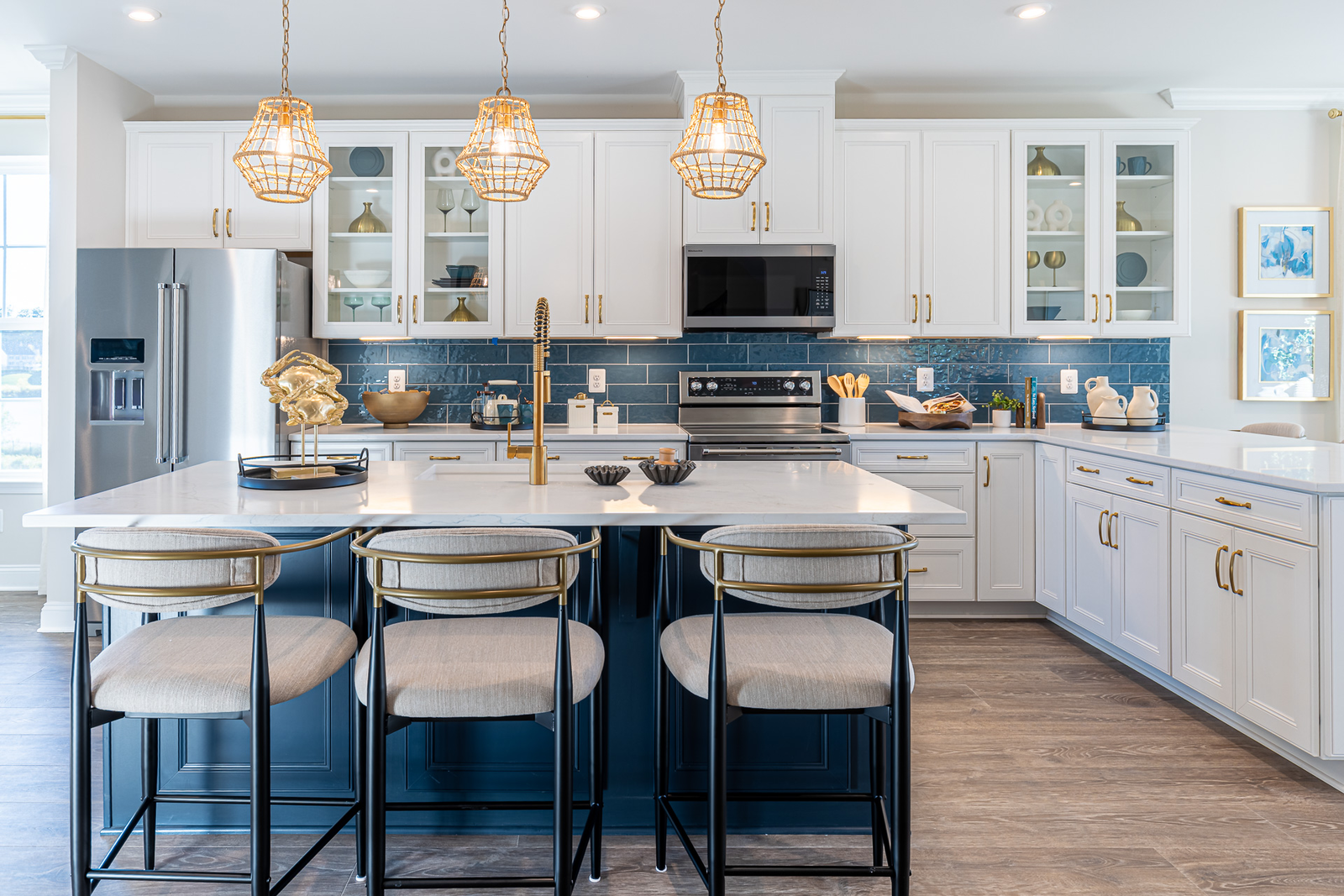 kitchen with a blue statement island and barstools