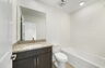 single sink vanity, water closet and shower
