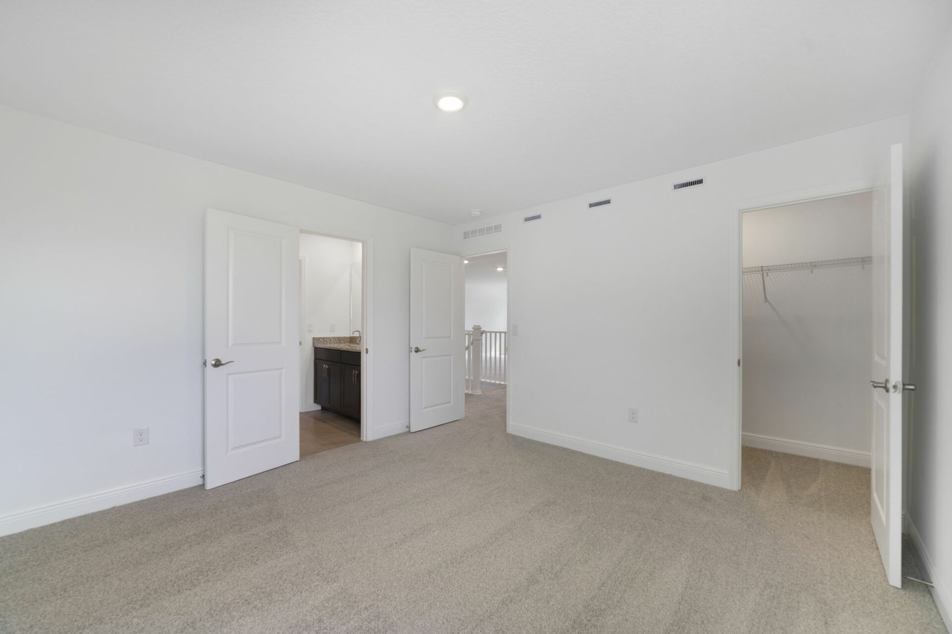bedroom with carpet, windows and access to closet