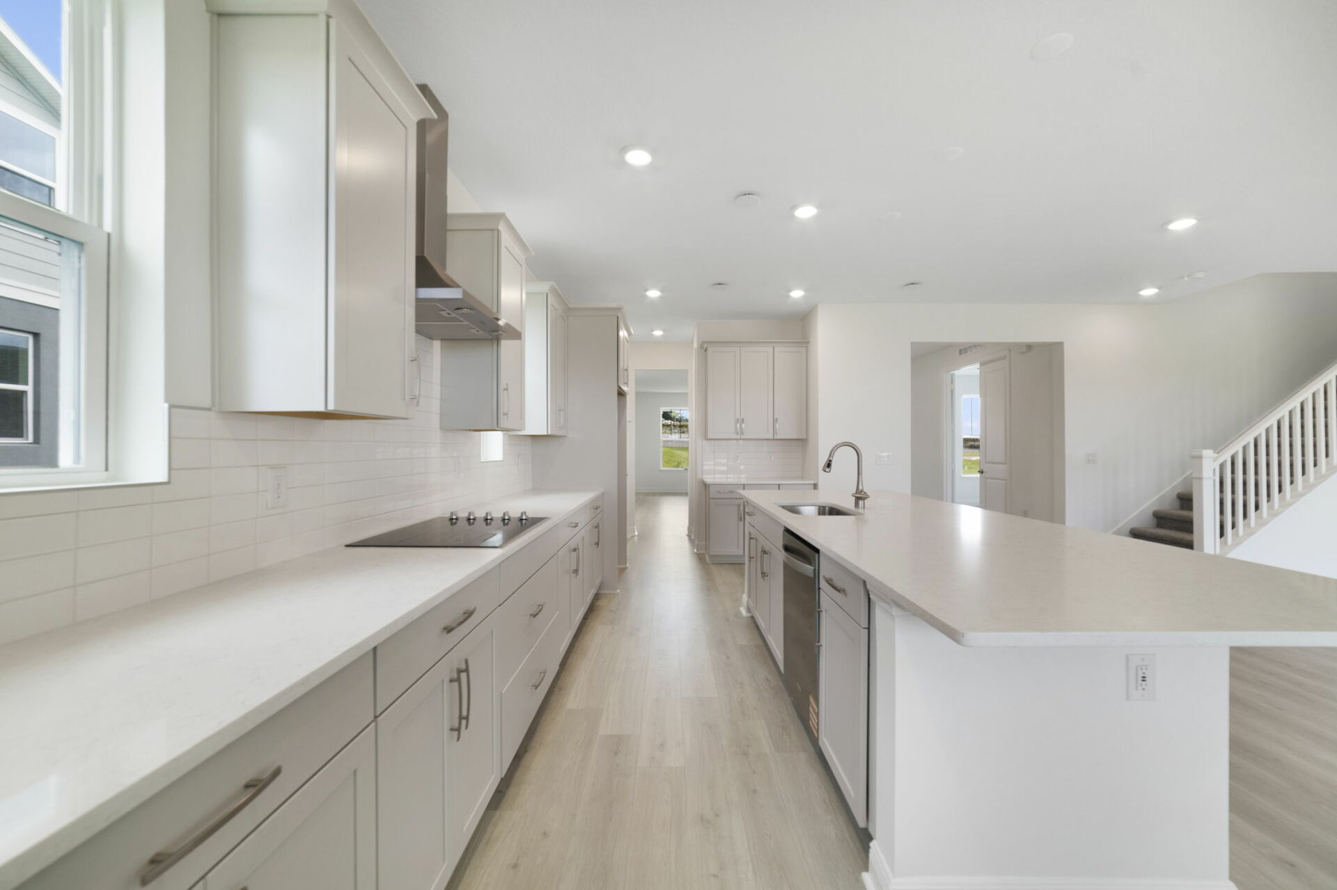 gourmet kitchen with view of great room and large windows