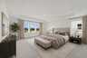 carpet throughout, multiple windows and tray ceilings  