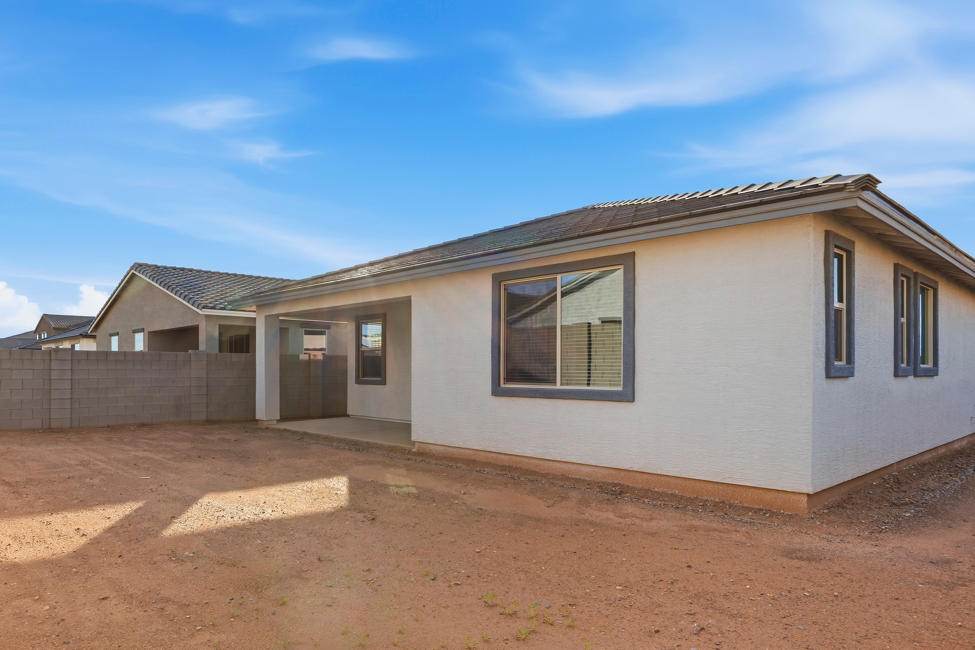 spacious backyard with concrete block wall