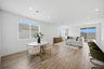 open-concept dining space with wood-like flooring, a round dining table, and white chairs