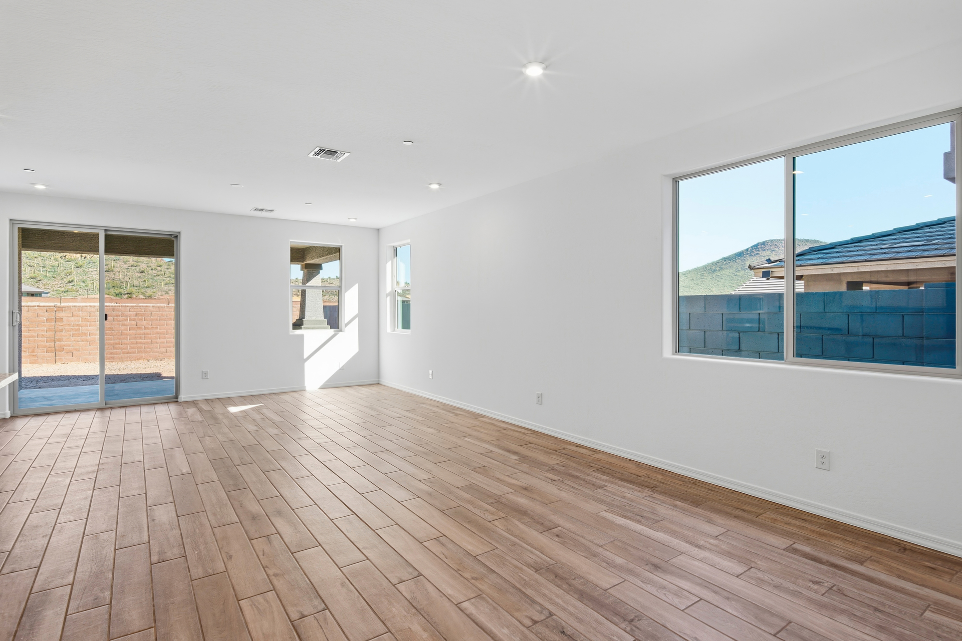 open-concept space with wood-like flooring and recessed lights