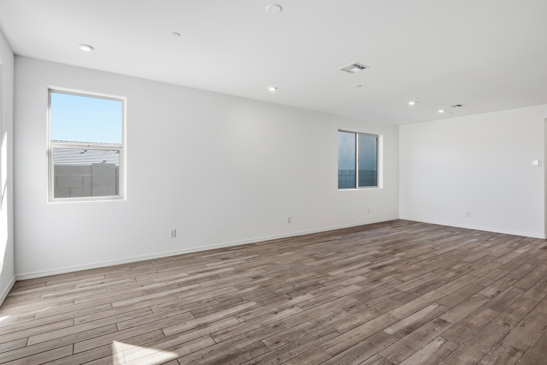 open-concept space with wood-like flooring and plenty of natural light