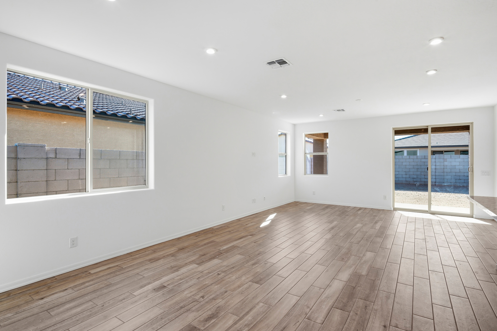 open-concept space with wood-like flooring and recessed lights