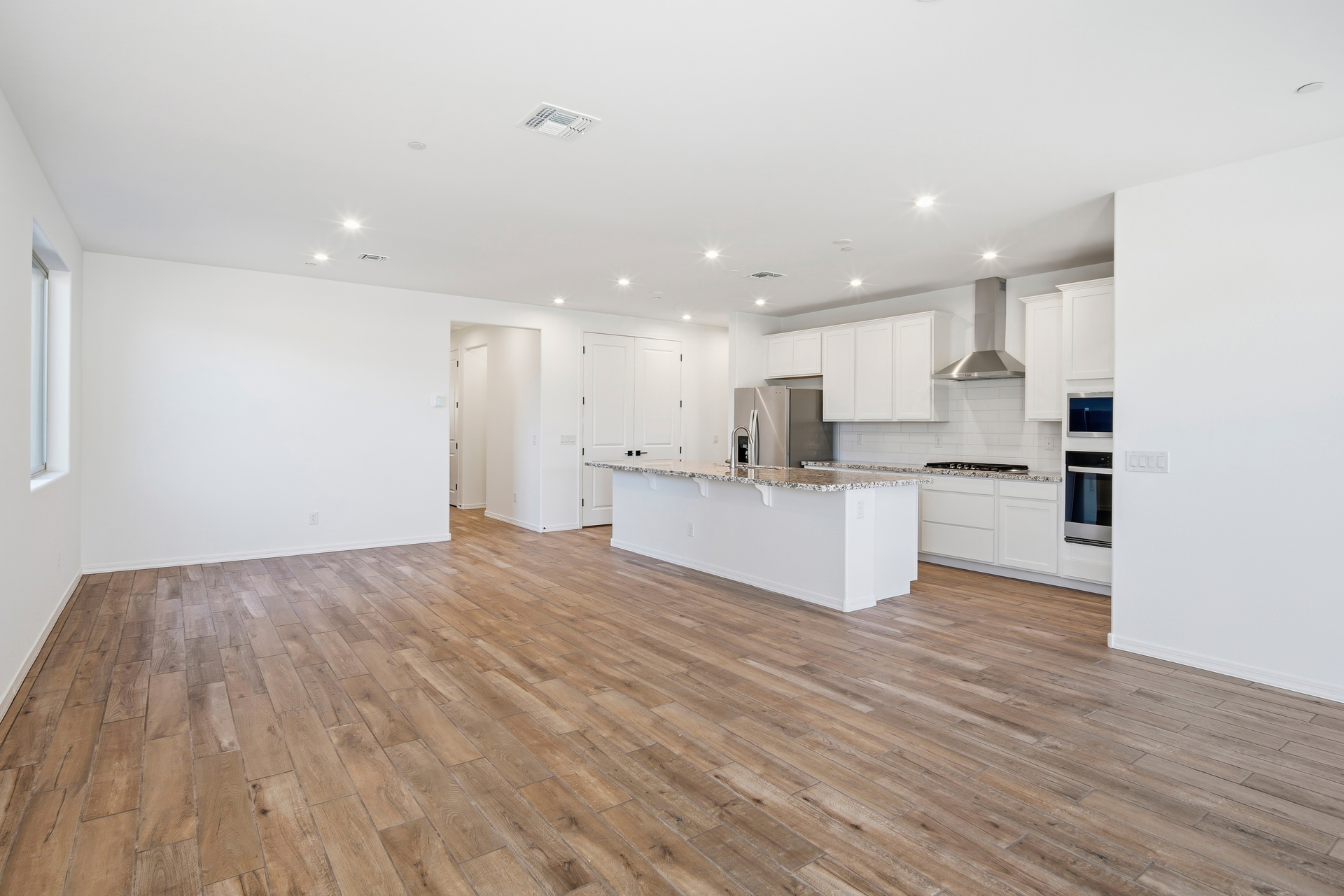 open-concept space with wood-like flooring and plenty of natural light