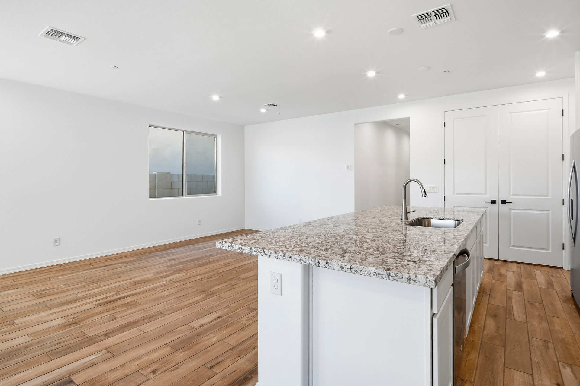 kitchen with granite countertops, white cabinets, and stainless-steel appliances
