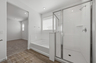 spacious bathroom with a walk-in shower and soaking tub