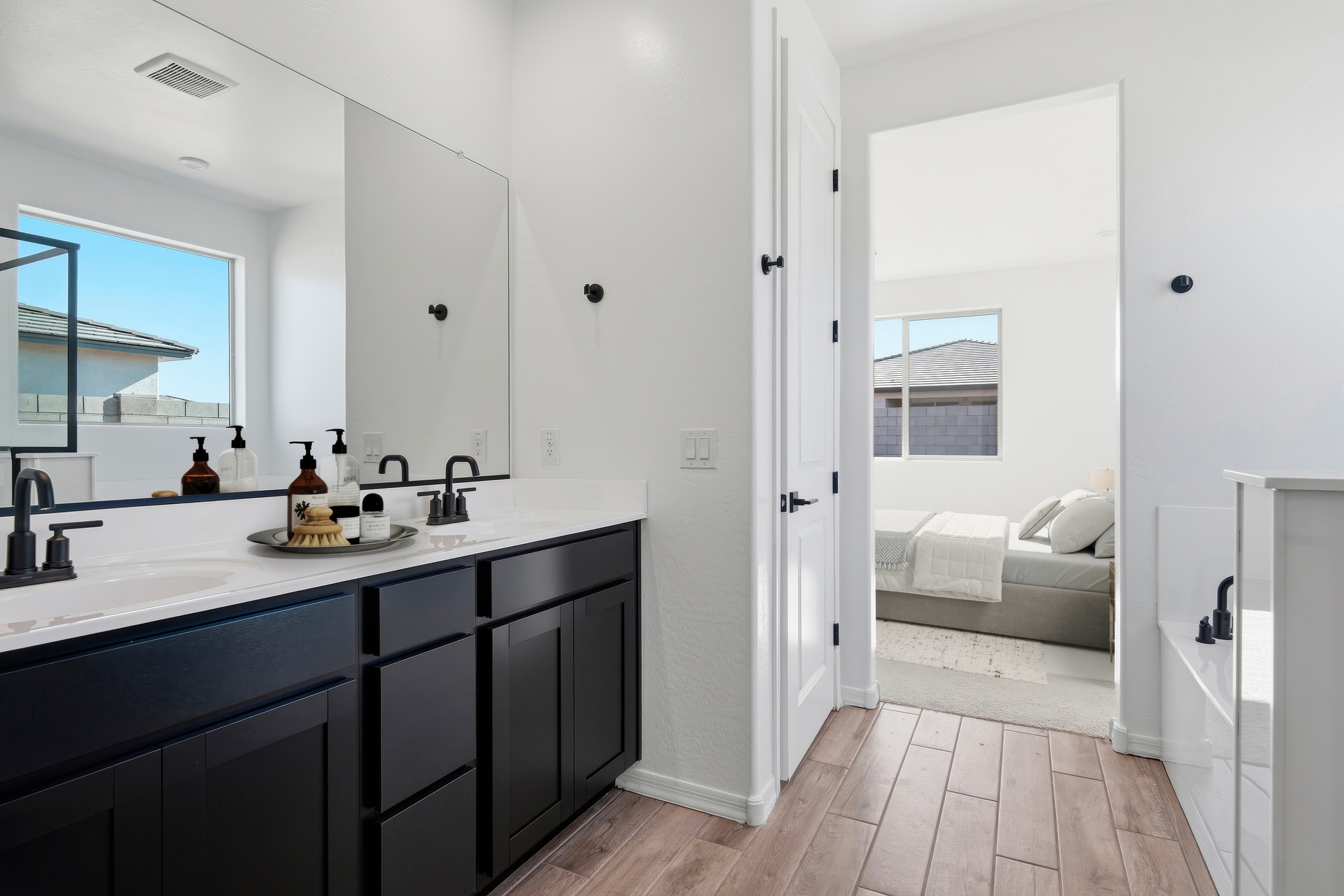 bathroom with double sink and black faucets 