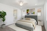 spacious bedroom with a king-sized bed, white rug, and white nightstands