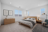 spacious bedroom with a king-sized oak bedframe, oak nightstands, and a large oak dresser