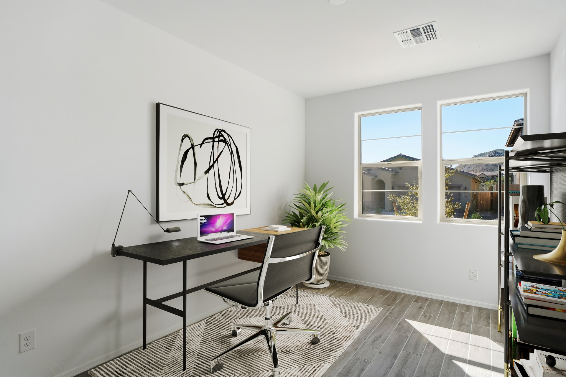 bedroom used as an at-home office with a black wooden table and a black office chair