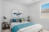bedroom with large bed, blue highlight color, and wooden nightstands
