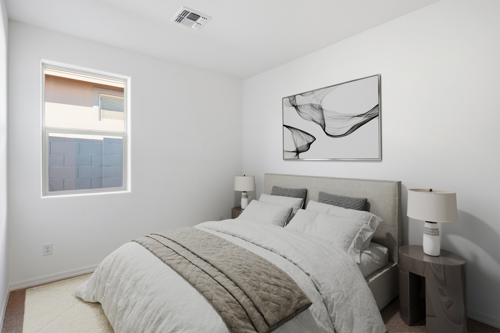 bedroom with a large bed and artwork on the wall