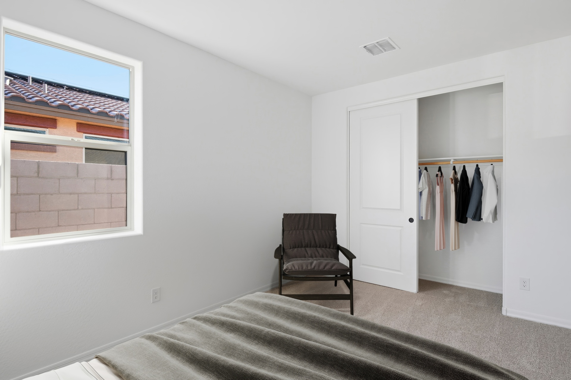bedroom with large bed and black accent chair